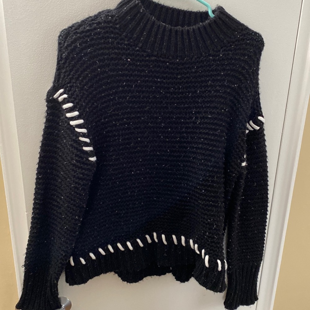 Black sweater with white stitching